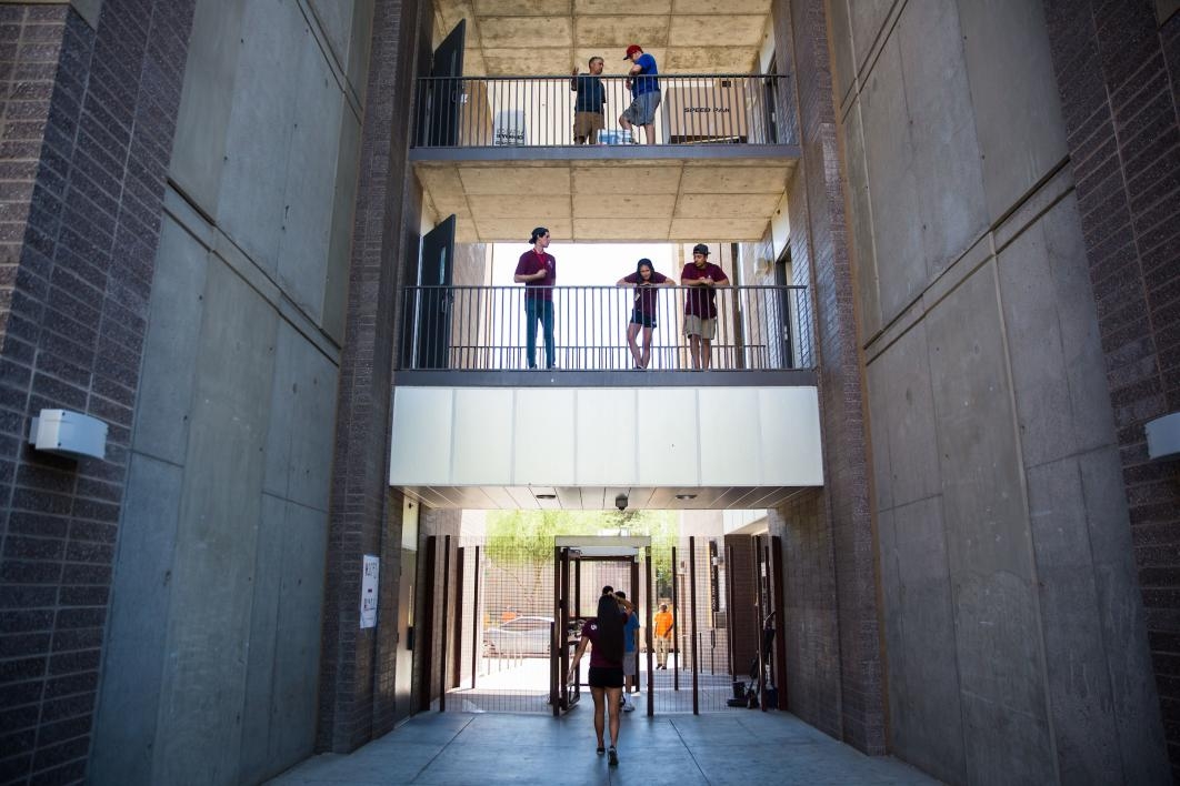 people standing on dorm balconies