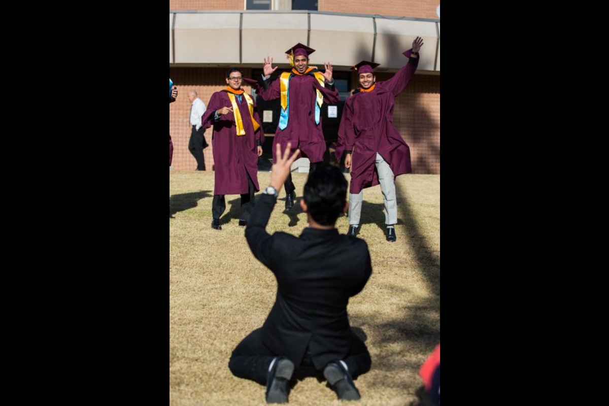 graduates pose for photo