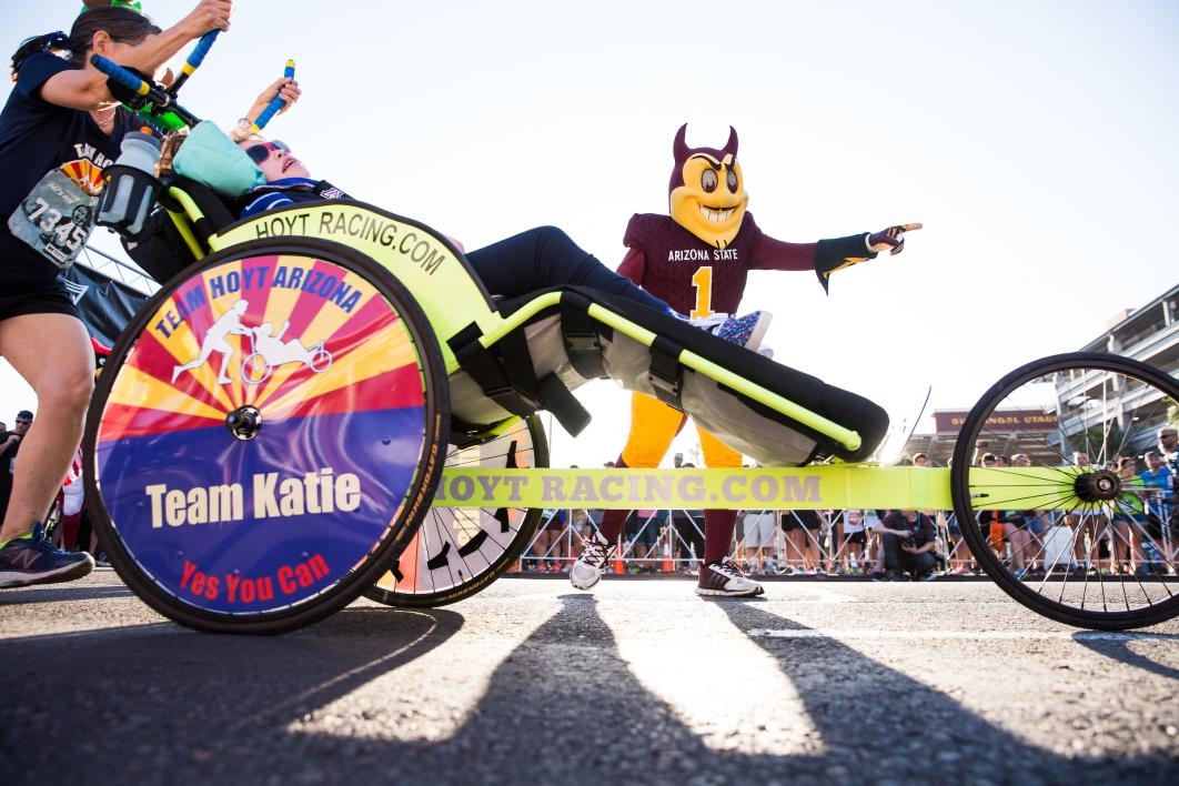 A race participant in a wheelchair and her family start Pats Run
