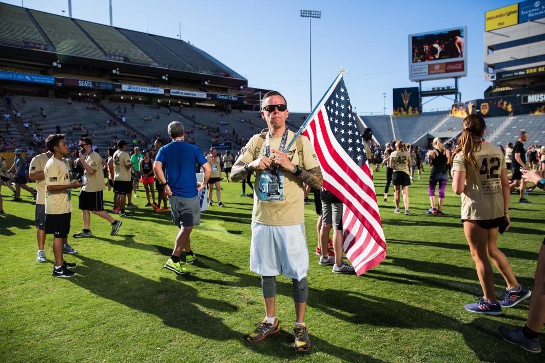 A veteran holds a US flag after Pats Run