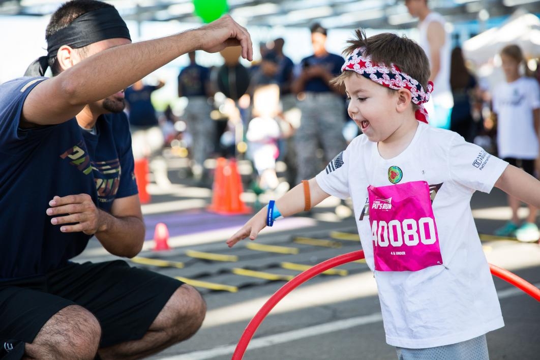 A little kid learns to hula hoop after Pats Run