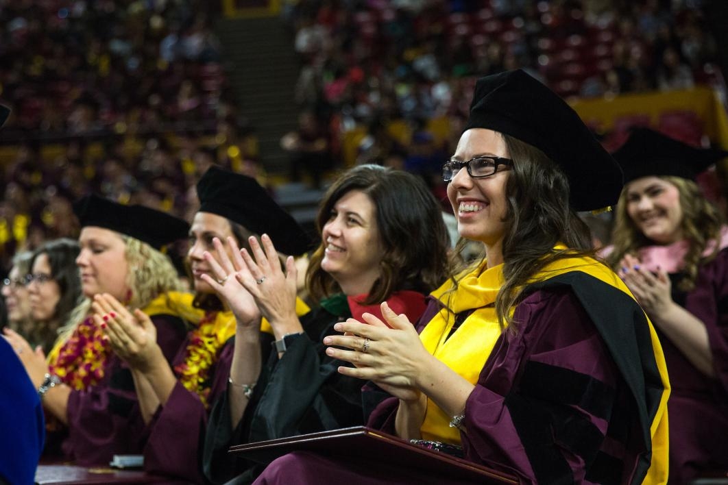 graduate clapping during ceremony