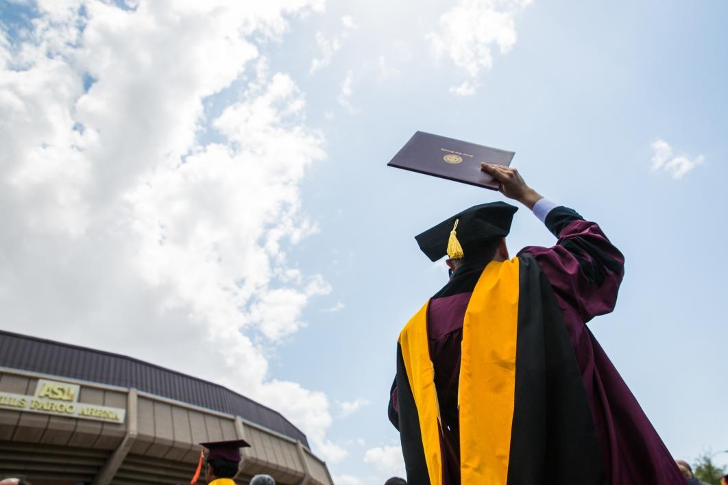 graduate holding diploma in air