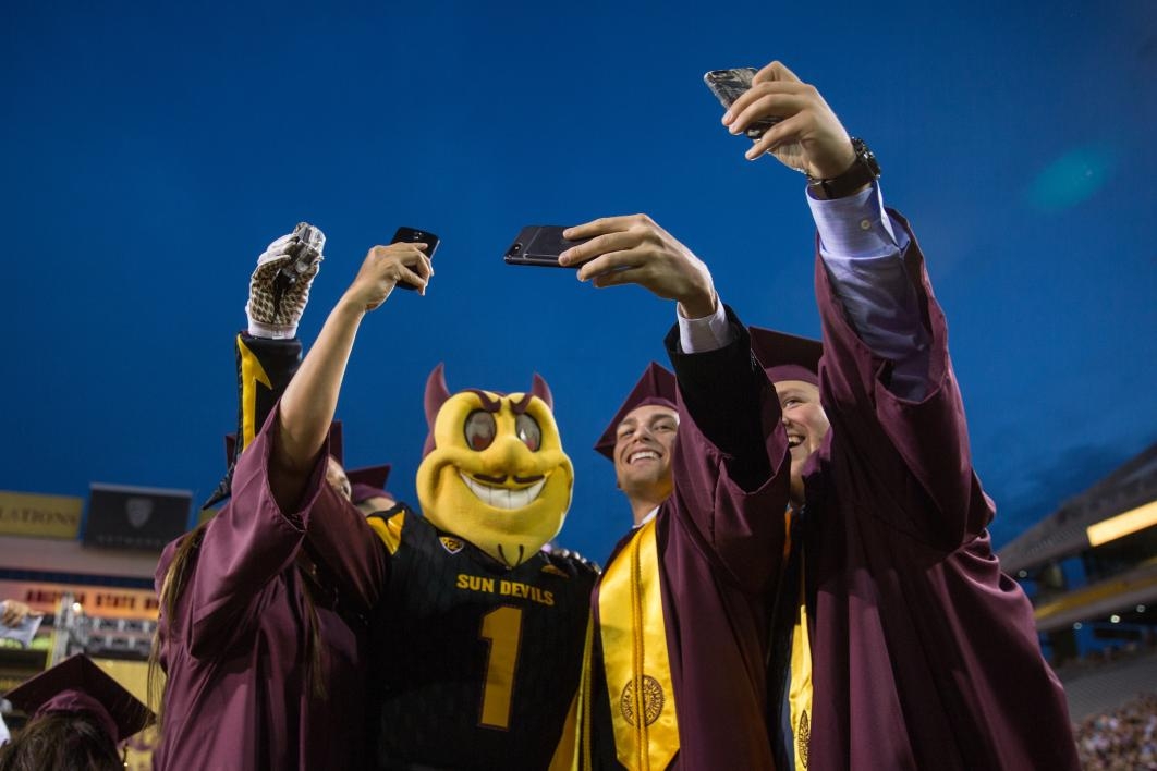 grads taking selfie with Sparky