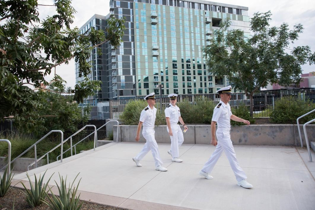 three people in uniform walking