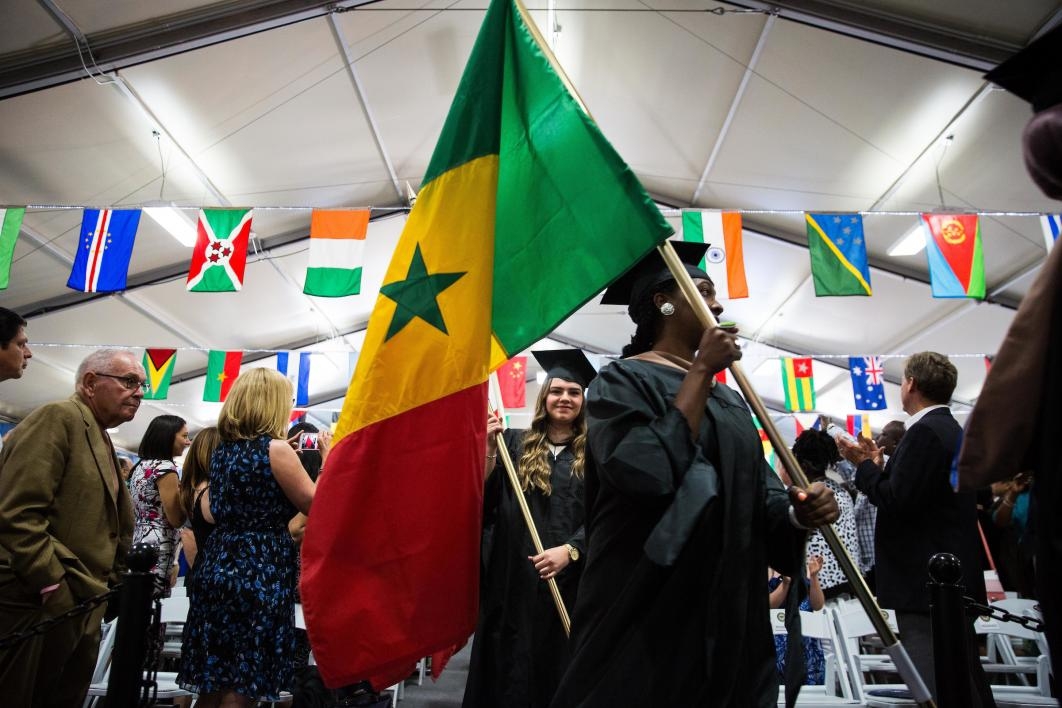 Graduates carry flags at the Thunderbird School of Global Management commencement