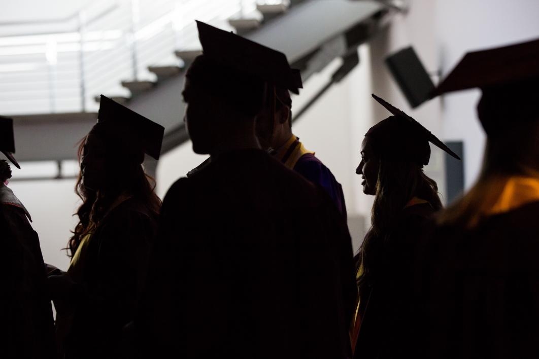 silhouette of graduates lined up