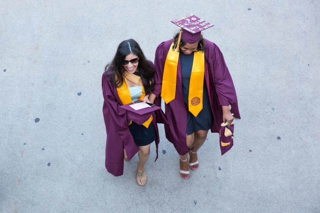 two grads walking to convocation
