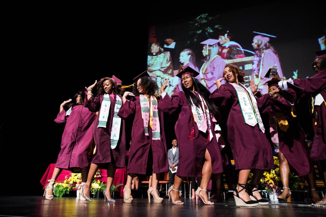 sorority members cross graduation stage together