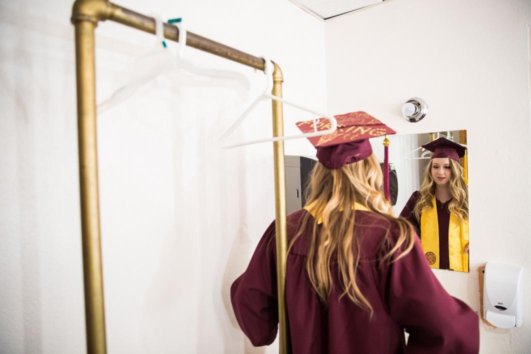 graduate looking in the mirror