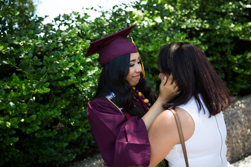 graduate embracing mother