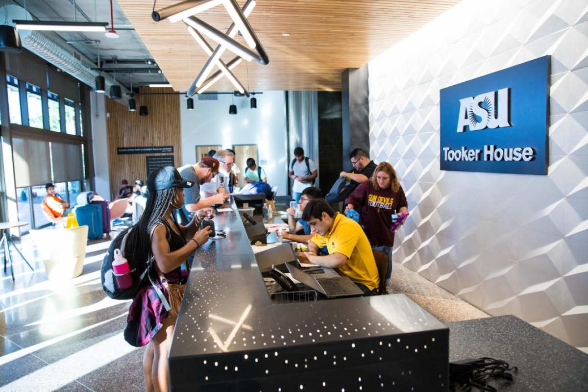 Students check in at the front desk of Tooker House