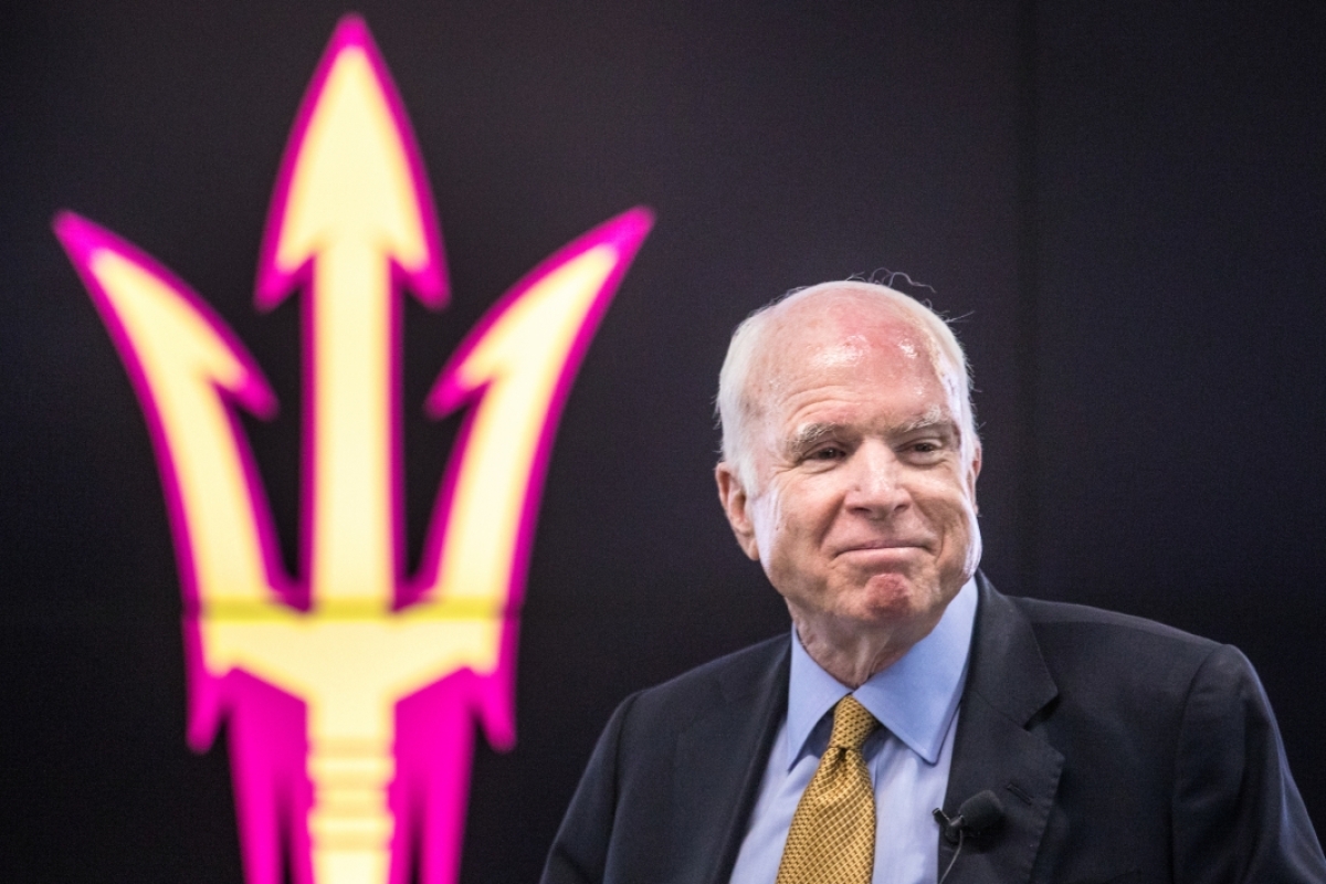 Sen. John McCain smiles with an ASU pitchfork in the background