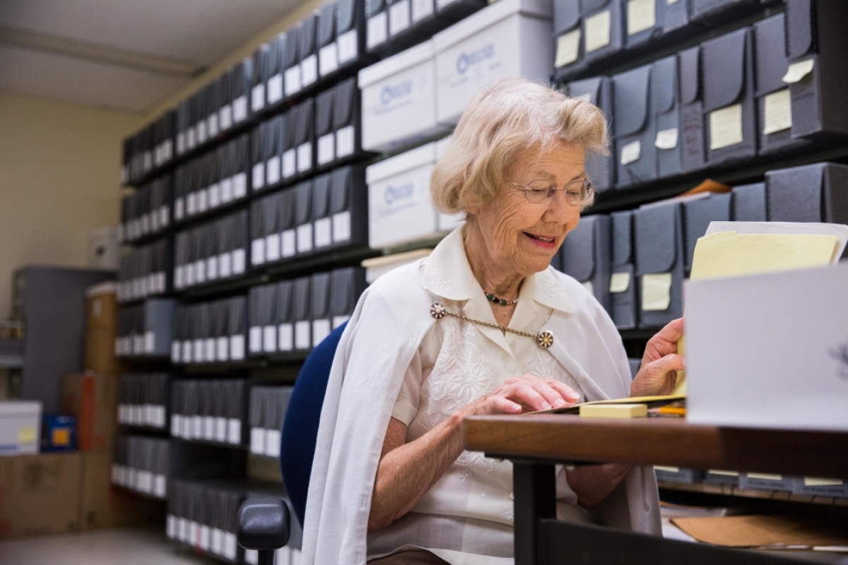 woman at desk in library collection