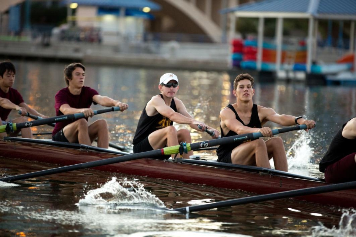 men's rowing team on lake