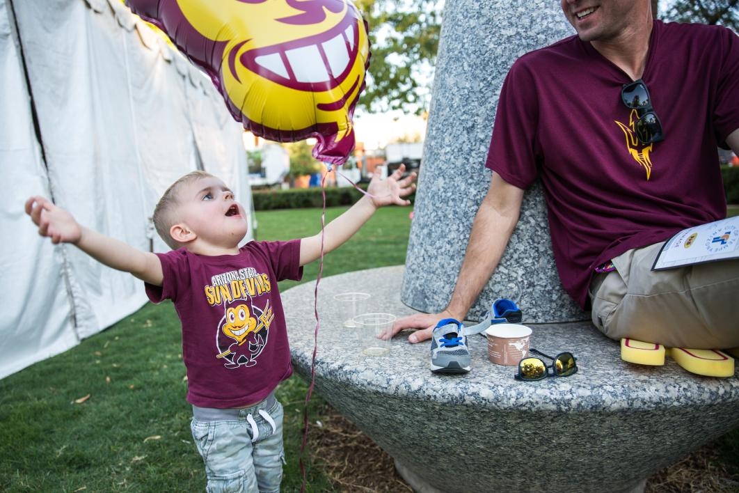 child playing with Sparky balloon