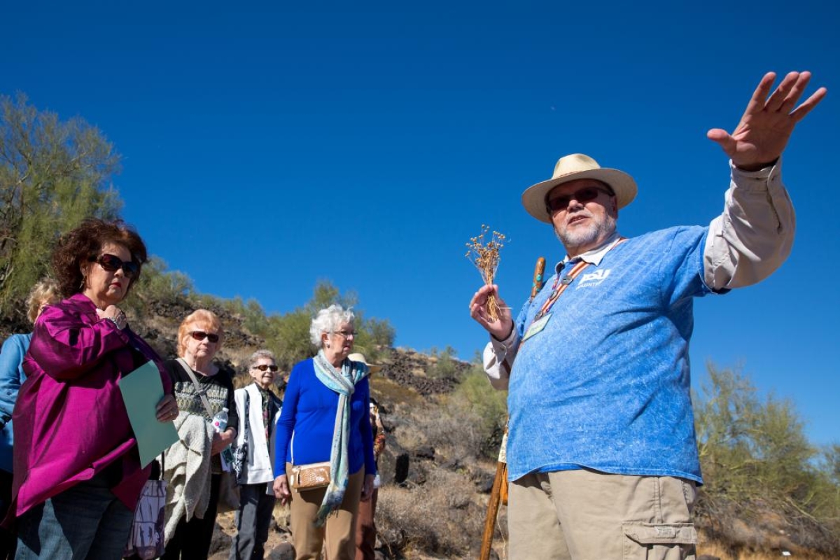People take a tour at the Deer Valley Petroglyph Preserve