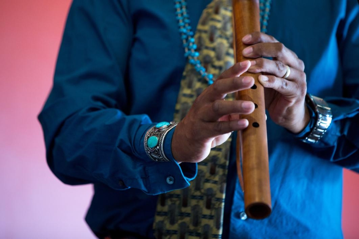 A man plays a Native American flute