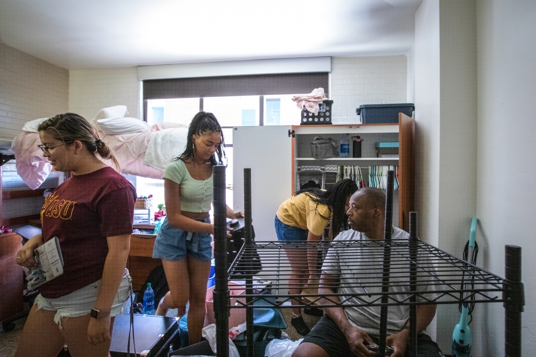 family assembling furniture in a dorm