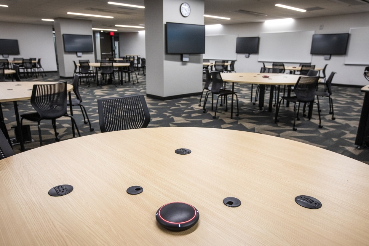 round tables and television screens in a classroom