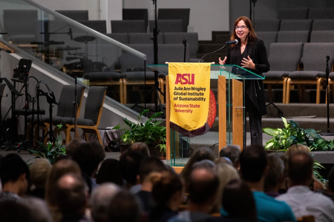 Climate scientist Katharine Hayhoe speaks from the front of a church