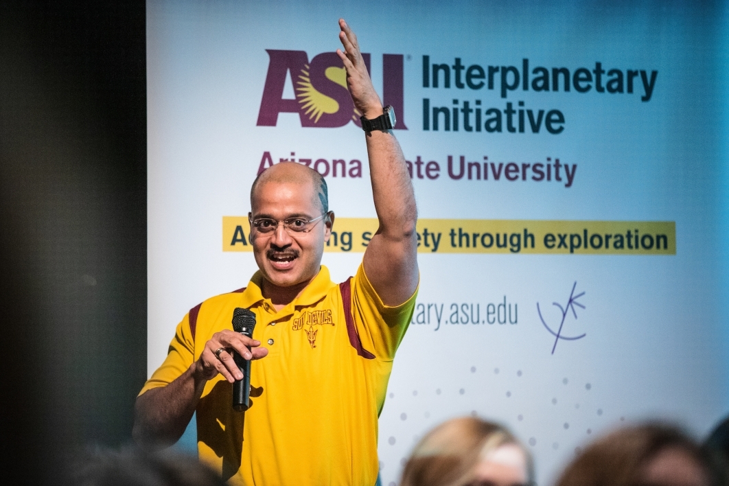 A man speaks onstage at the ASU Space to Thrive space missions panel
