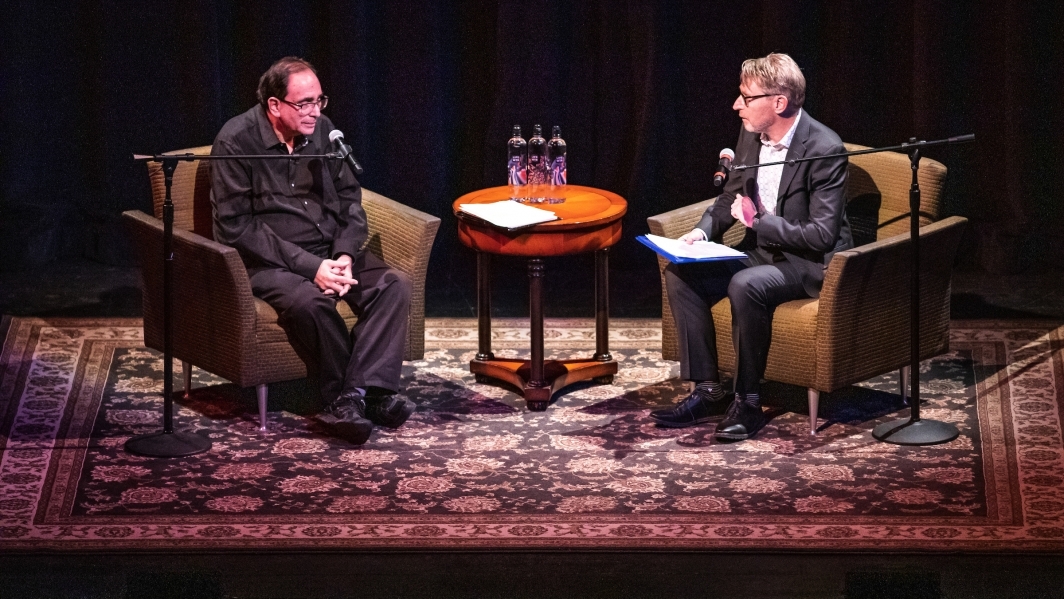R. L. Stine and ASU Dean of Humanities Jeffrey Cohen seated on stage at the Orpheum Theatre in Phoenix