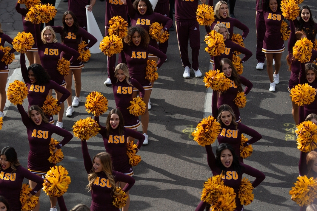cheerleaders march in the homecoming parade