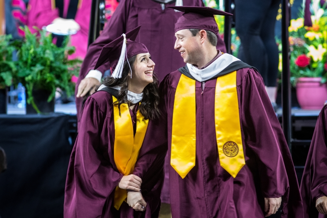 couple walks after graduation
