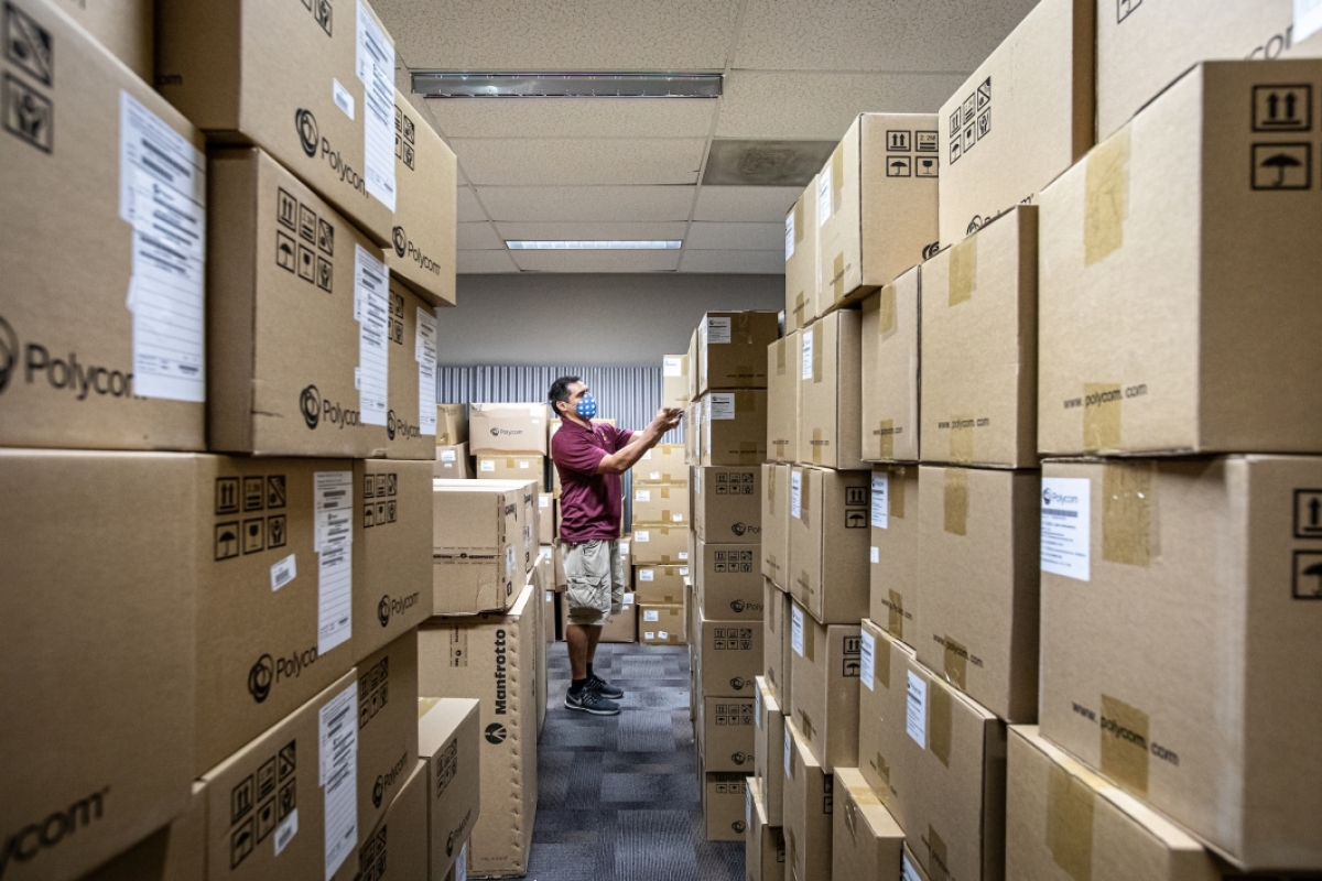 UTO tech looks at stacks of boxes