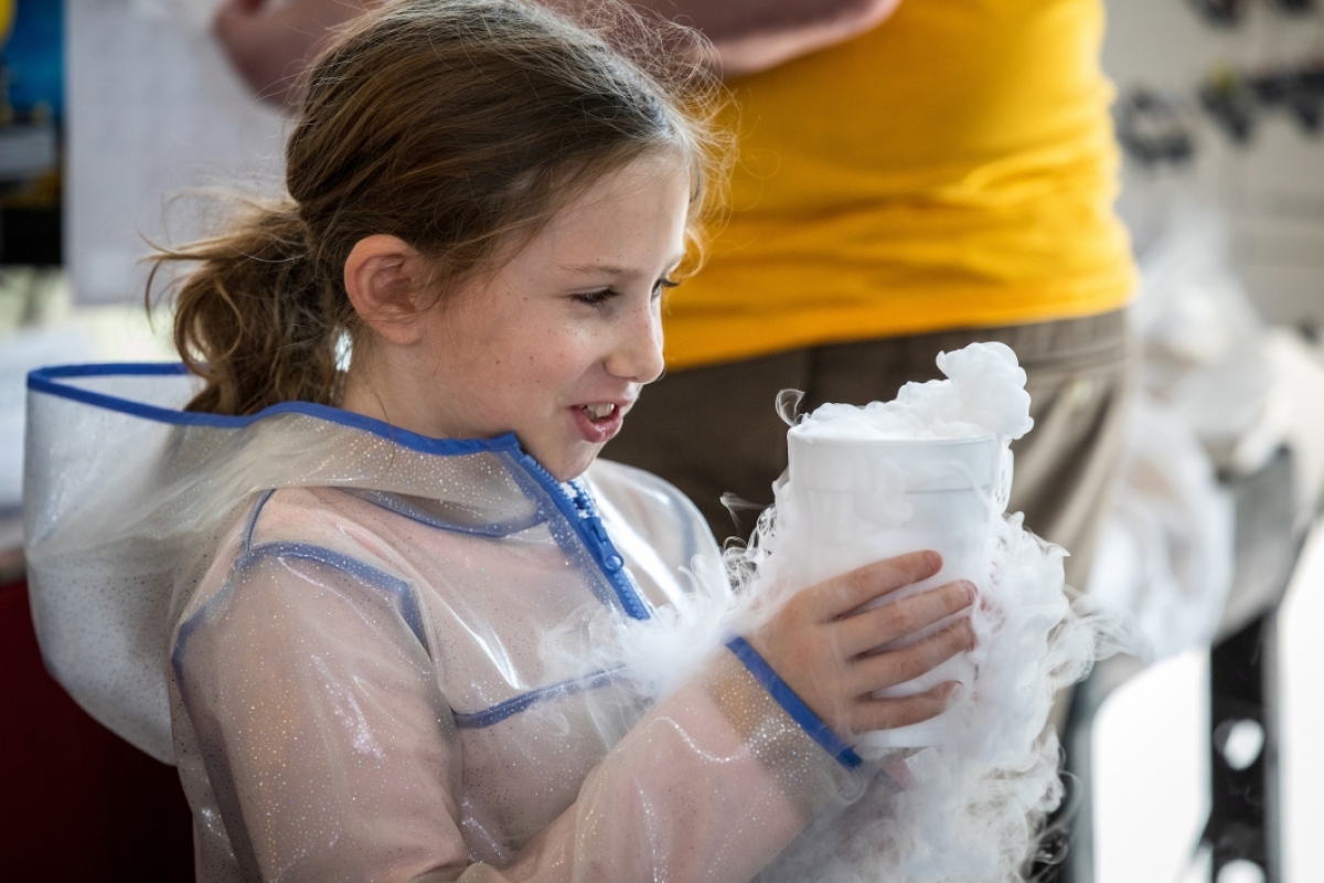 girl holding cup of dry ice