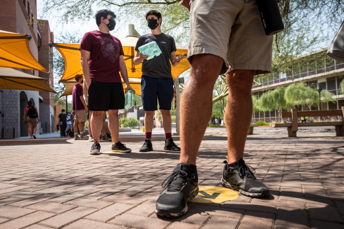 Students wait in a socially distanced line to get into the ASU bookstore on the first day of class