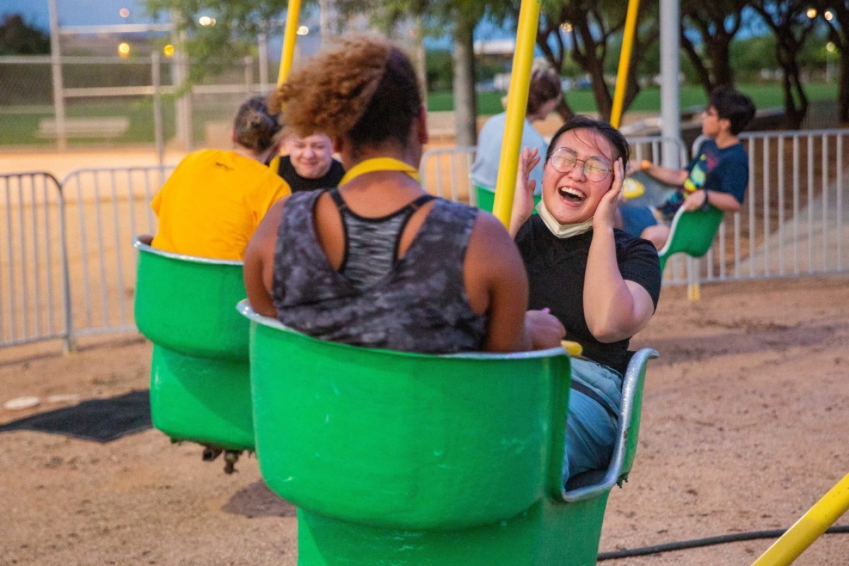 Woman laughing on a carnival swing ride
