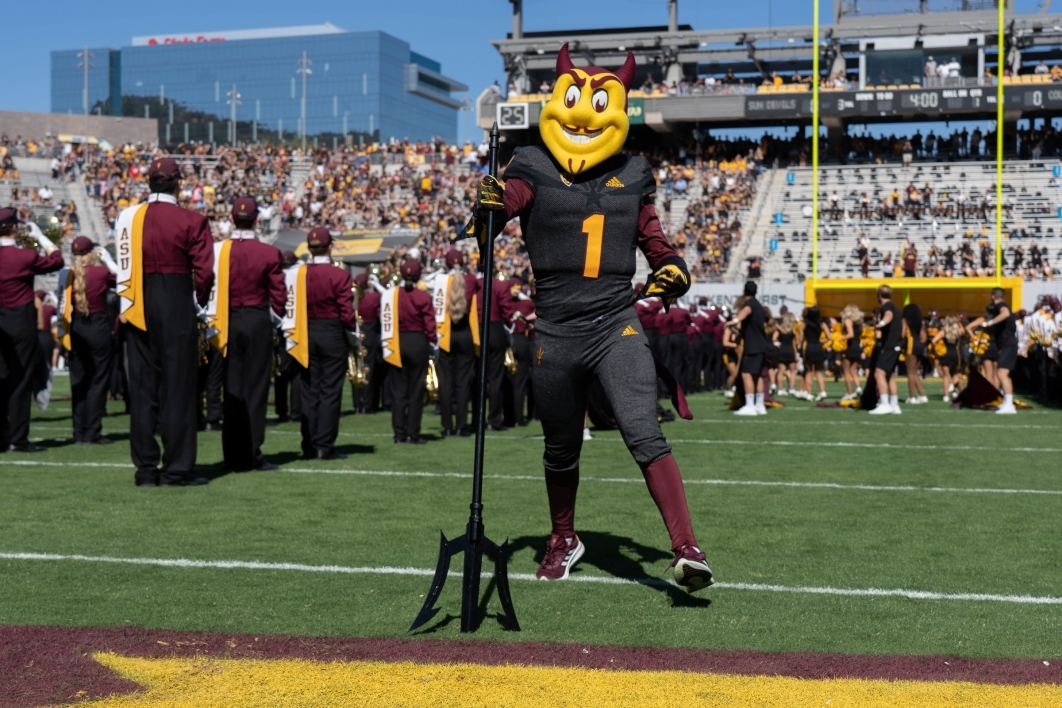 Sparky the ASU mascot stands with his pitchfork thrust into the football turf at the start of the Homecoming game