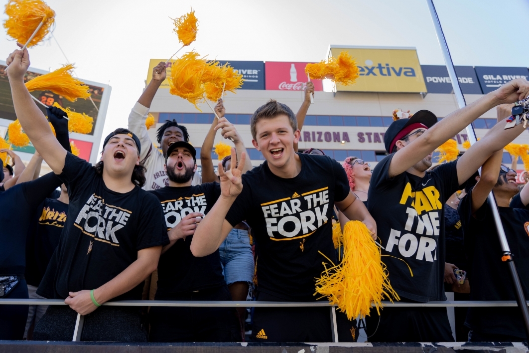 Students wearing shirts that say Fear the Fork cheer before the ASU football game