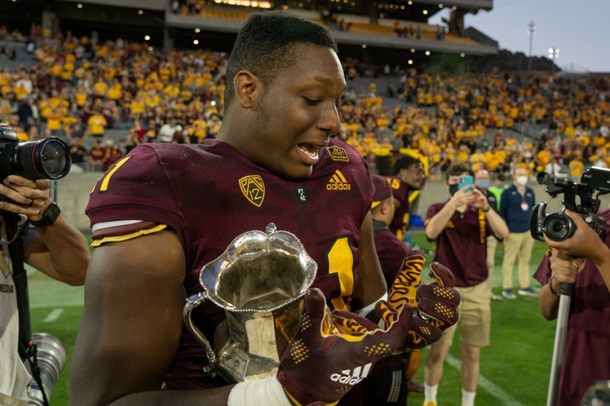 football player holding Territorial Cup and crying