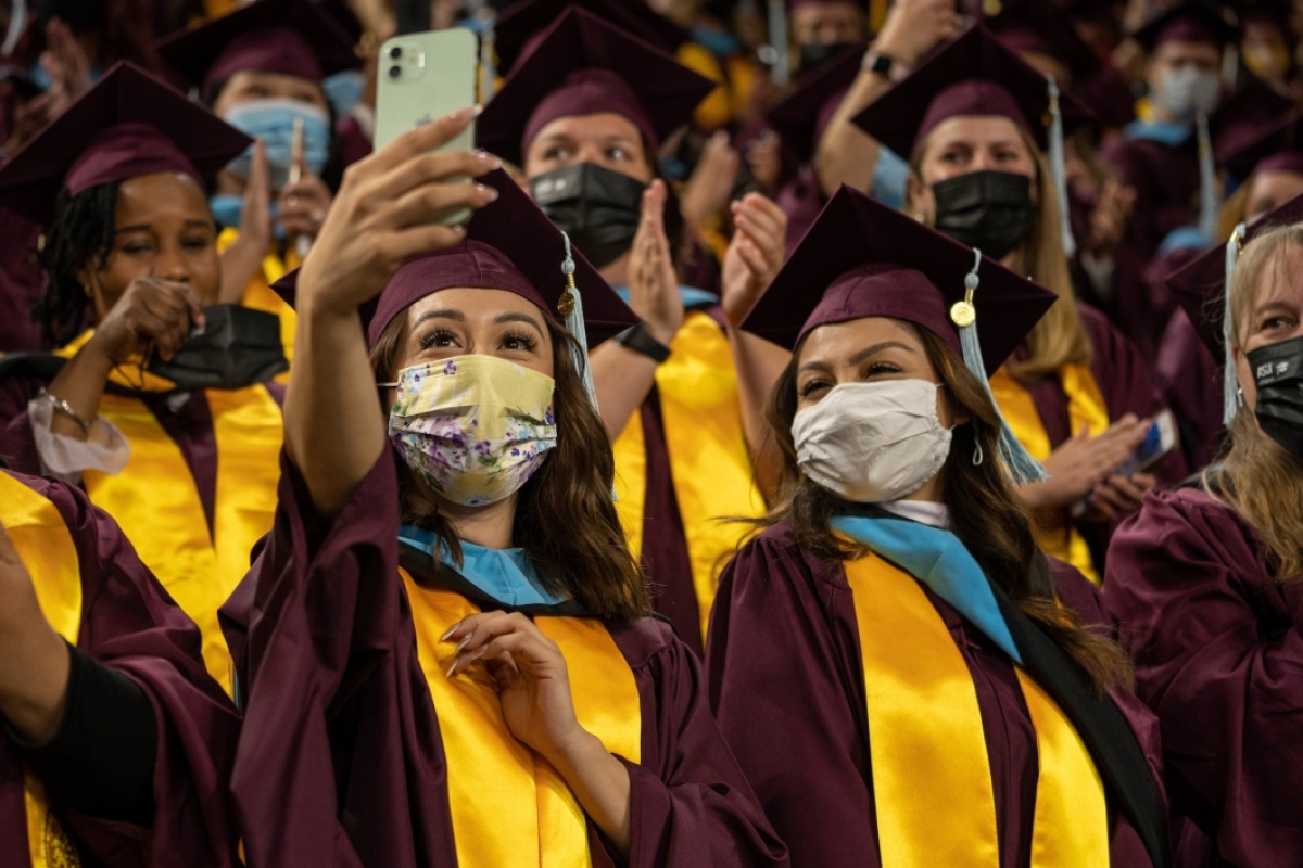 students taking selfie at commencement