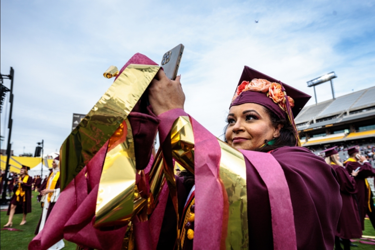 graduate taking photos with phone