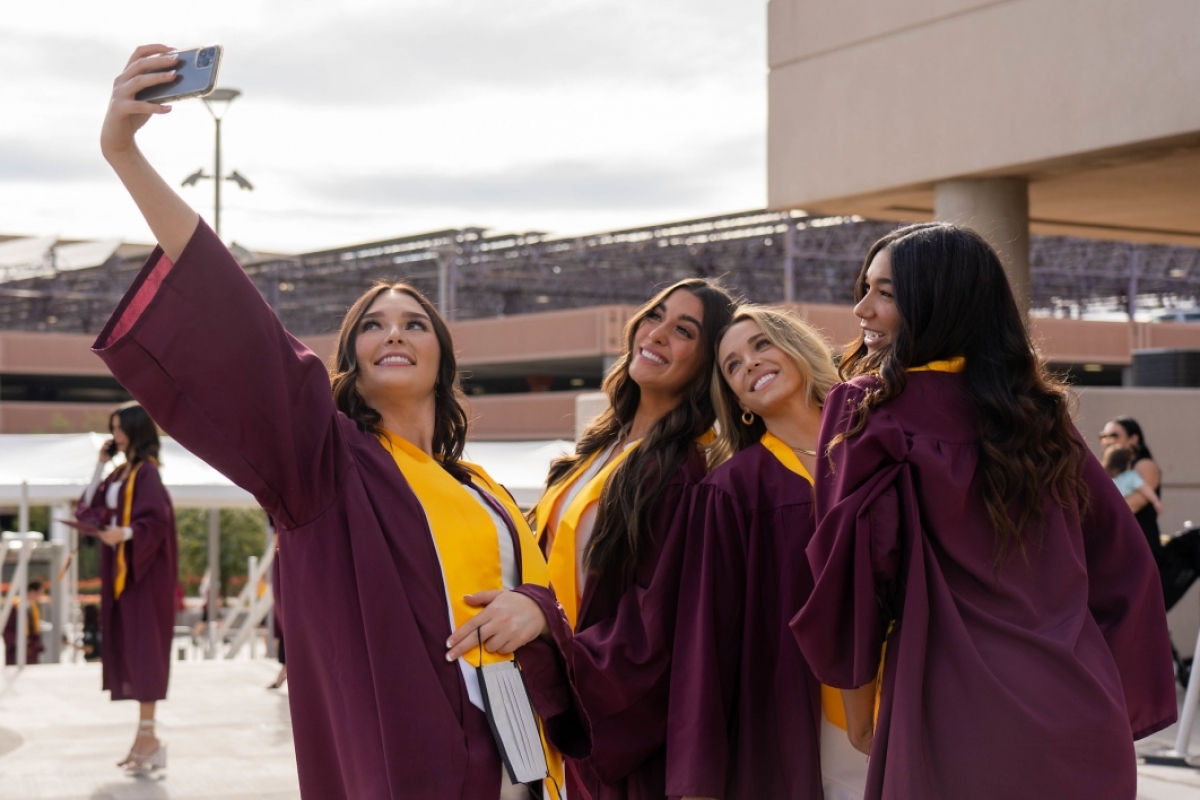students posing for selfie at graduation