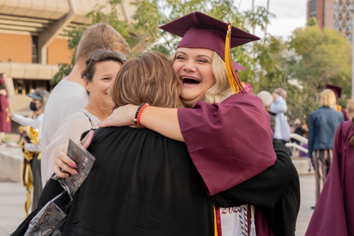 student and mom hugging after graduation