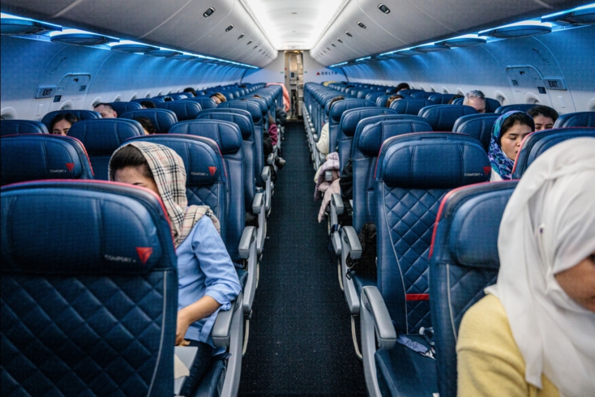 Women are sprinkled throughout a large plane