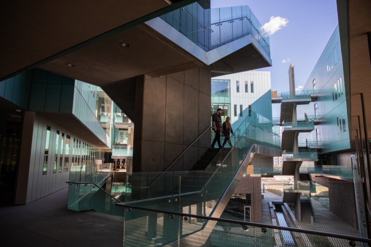 Two people walking down stairs inside the courtyard of ISTB7
