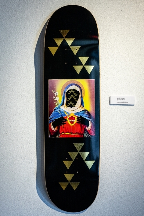 Skateboard painted with an image of the Virgin Mary holding a sacred heart.