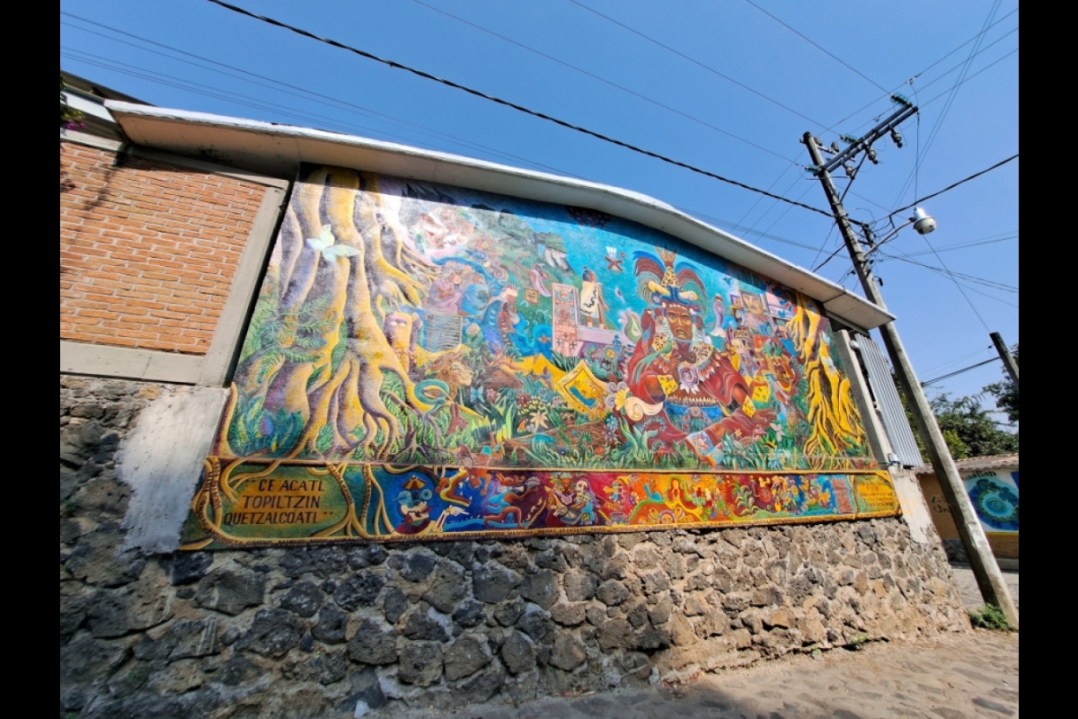 Brightly colored mural on a buidling's exterior wall.