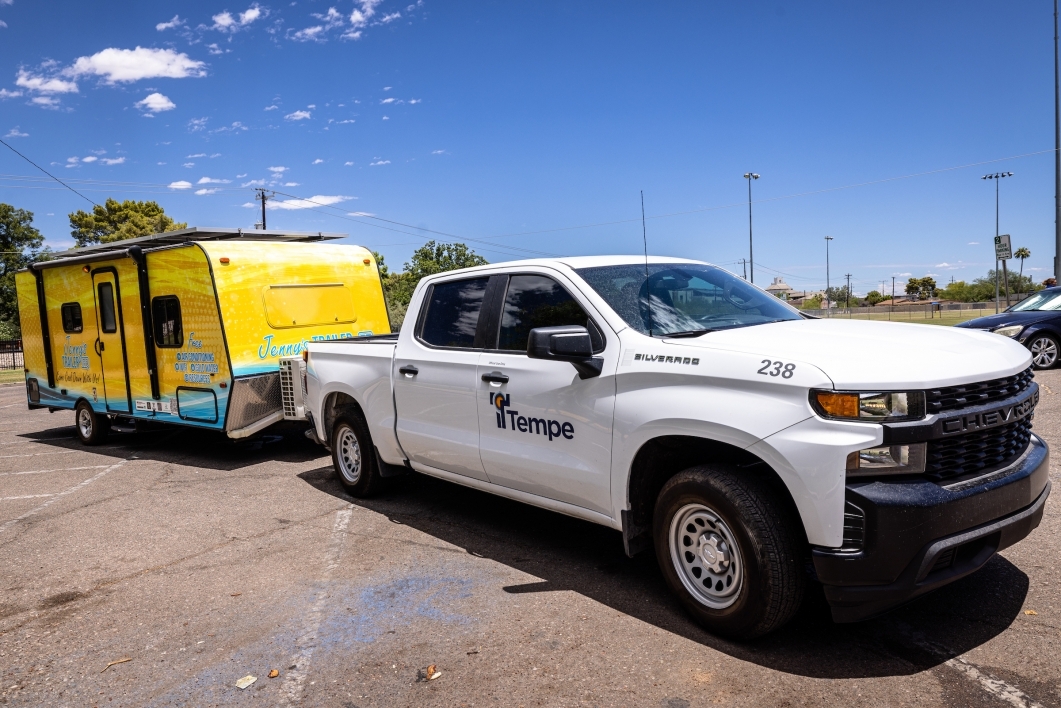 White truck hauling a yellow trailer