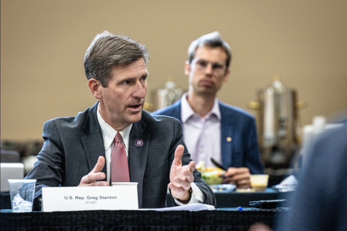 U.S. Rep. Greg Stanton speaks at a table with his nameplate in front of him