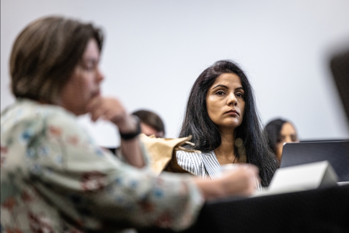A woman listens during a roundtable discussion