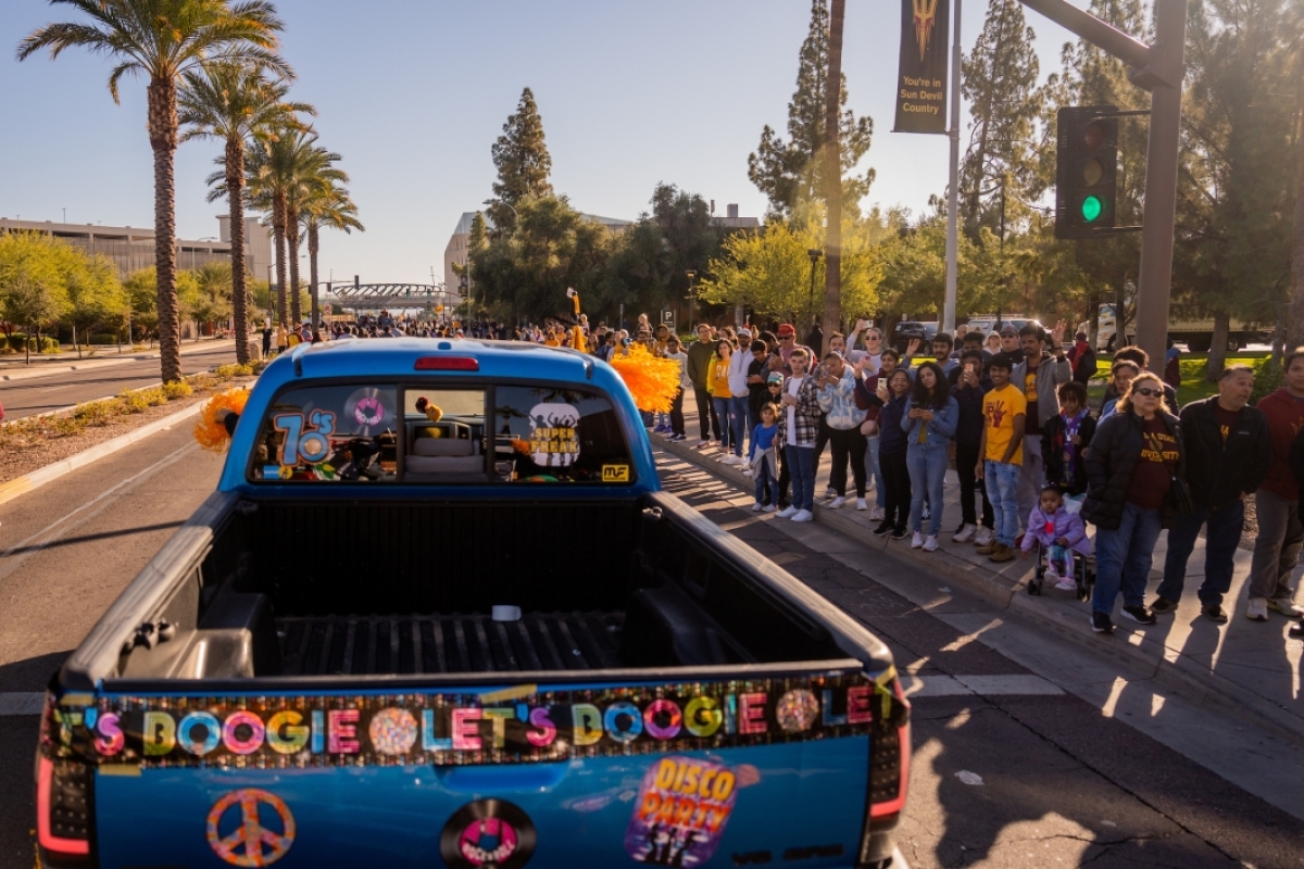 View of decorated truck pulling homecoming float during parade