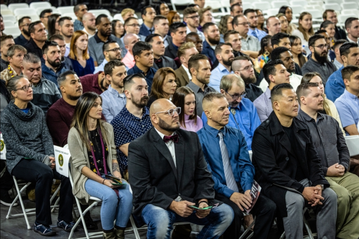 People seated in a crowd at a graduation ceremony.