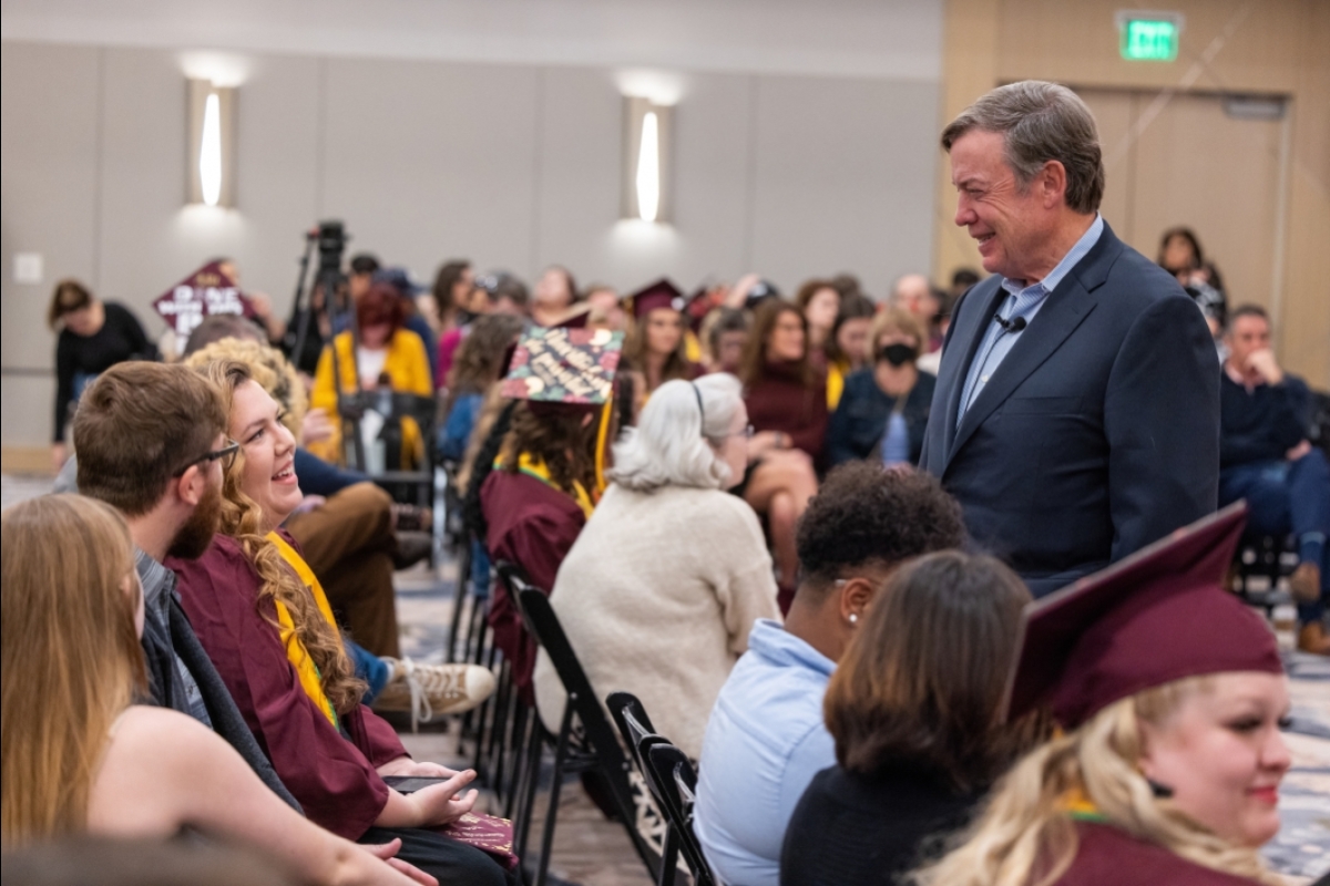 ASU President Michael Crow chats with attendees at an event